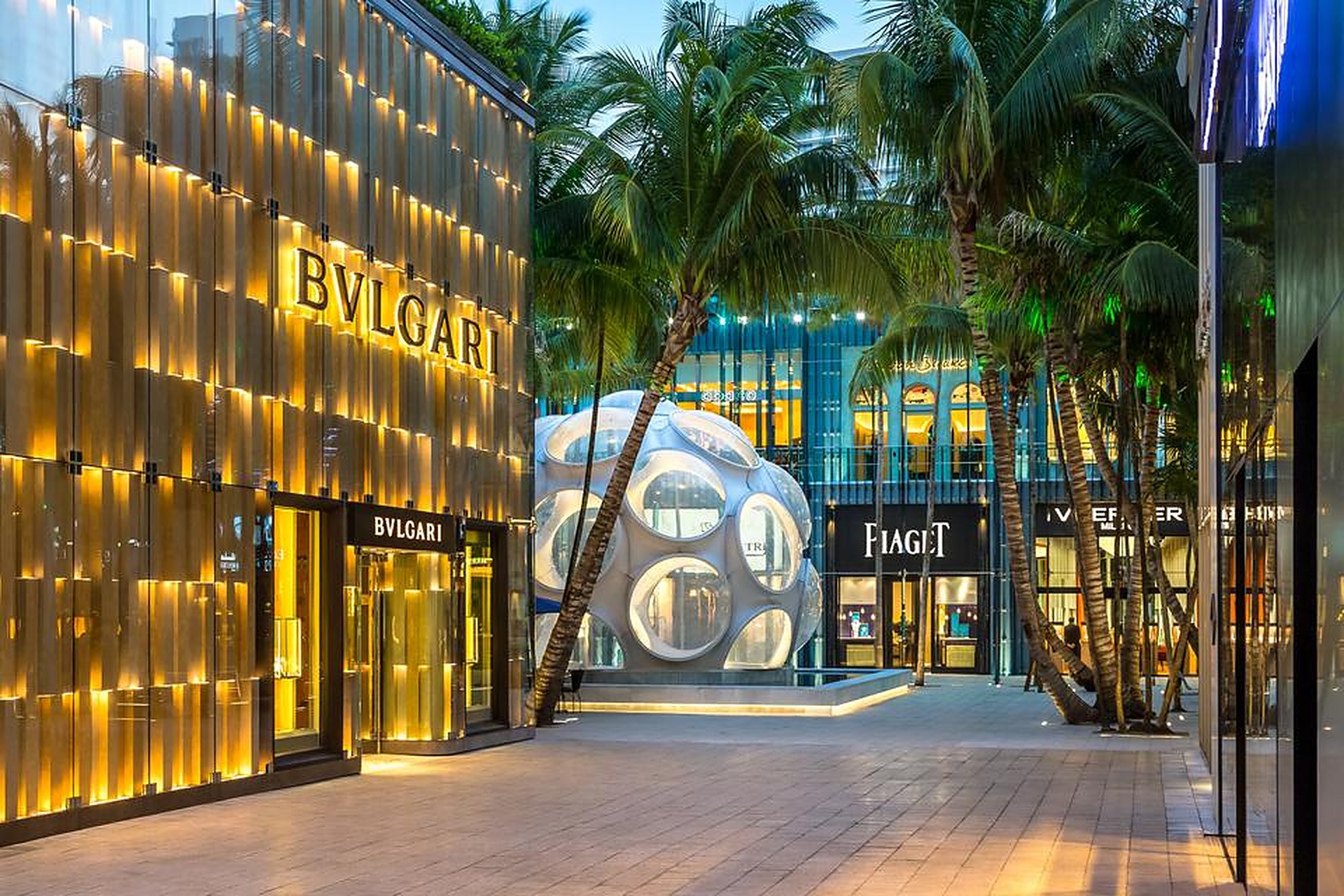 The Fly's Eye Dome and palm-lined Palm Court in the Miami Design District at dusk